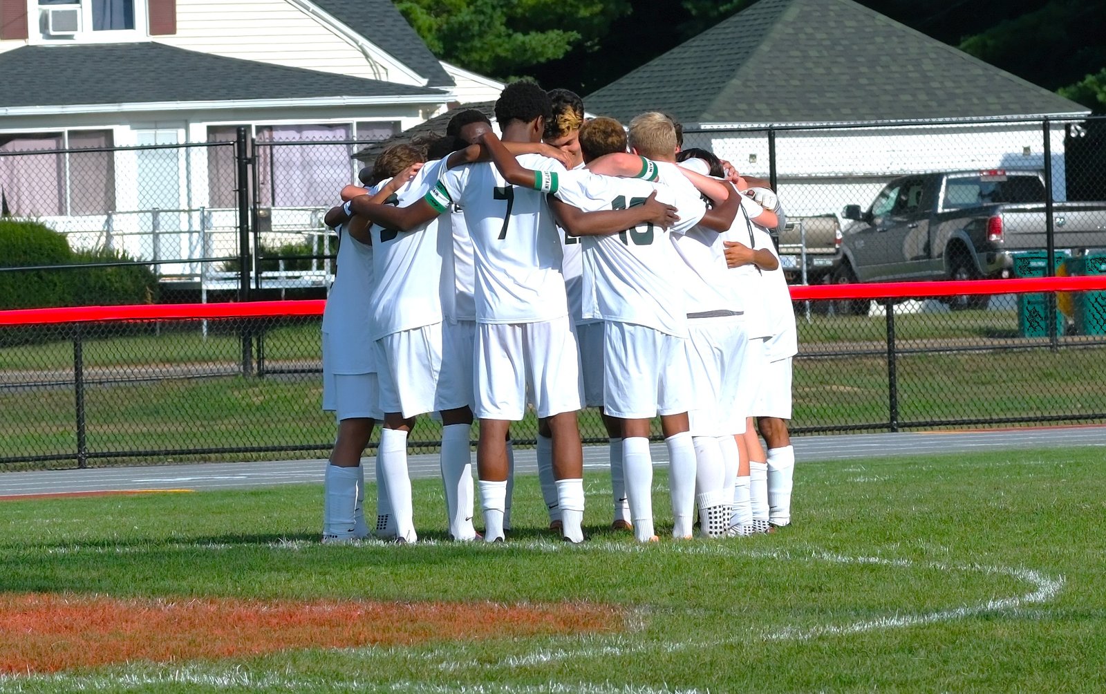 Central boys' soccer team huddled together before the season opener