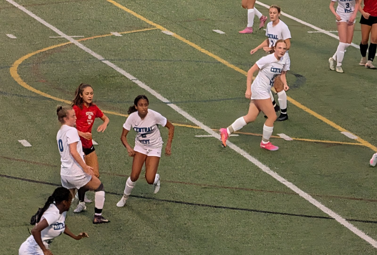 Central-West girls' soccer players chasing down the ball in a preseason match